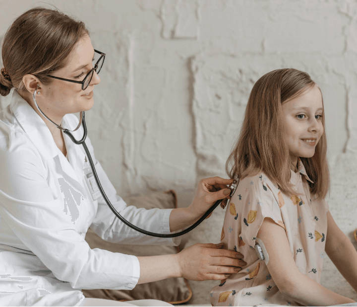 Doctor examining young patient with stethoscope